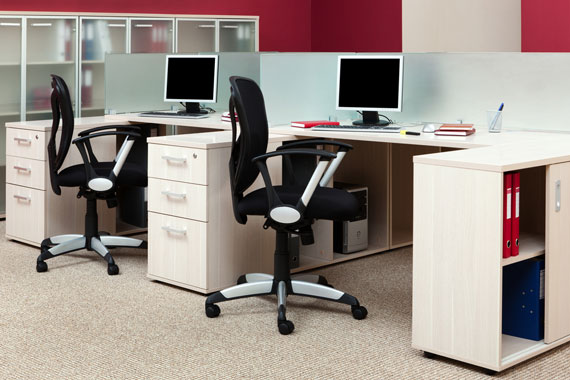 office interior with ergonomic seating, desks, and desktop computers